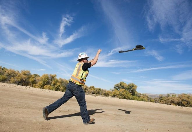 Louis Trujillo of Ames Construction tosses a drone into the air to take survey images of the Interstate 15 construction project during 2016 in Victorville between Stoddard Wells Road and D Street. Trujillo is a GPS Field specialist for the company and specializes in drone surveying. [DAILY PRESS FILE PHOTO]