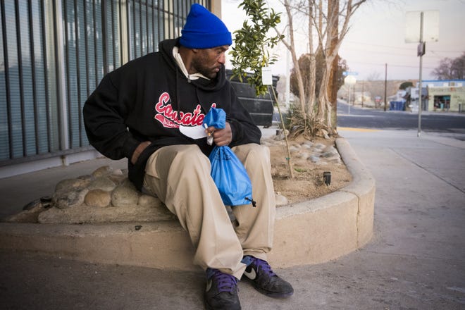 Tony waits for a nonprofit to open after talking to Point-in-Time Count volunteers in Old Town Victorville on Thursday. Point-in-Time Count is a nation and countywide census of the homeless conducted annually. [James Quigg, Daily Press]