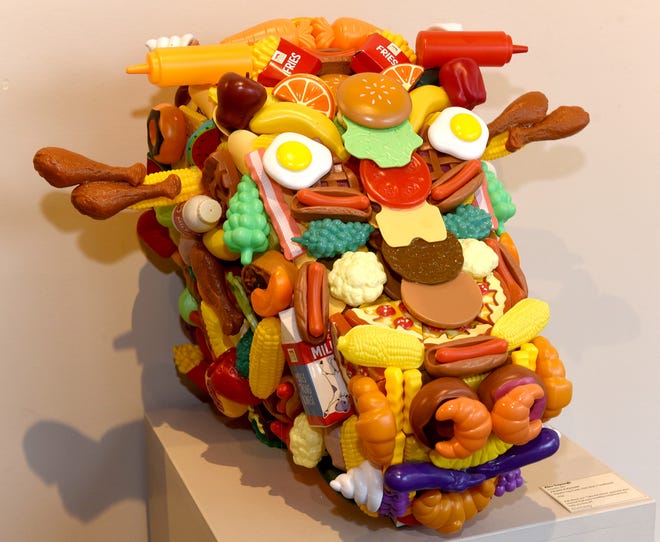 Alex Sapaugh's "Palate Pleasure," plastic toy food, hot glue, cardboard [Photos by Don Shrubshell/Tribune]