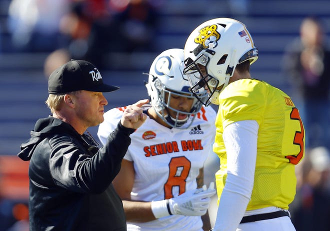North head coach Jon Gruden of the Oakland Raiders talks with North quarterback Drew Lock of Missouri (3) during a Senior Bowl practice Thursday in Mobile, Ala. [Butch Dill/The Associated Press]