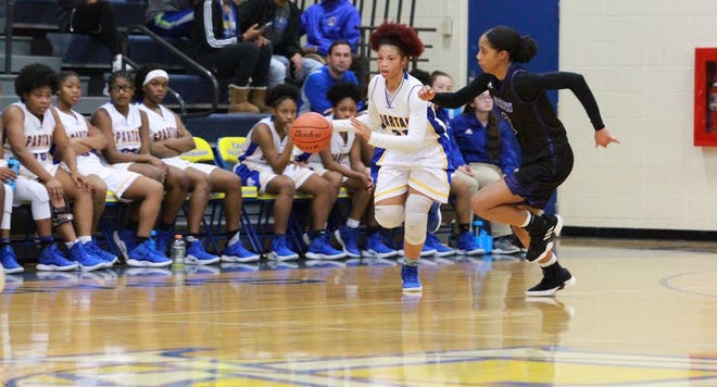 East Ascension's Aja Causey races down the court as she is bing guarded by Dutchtown's Zaria Harleaux. Photo by Kyle Riviere.