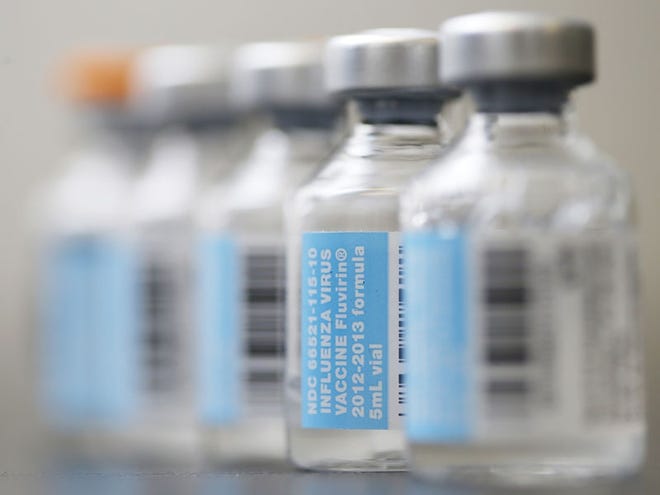 FILE-This Thursday, Jan. 10, 2013, file photo shows vials of flu vaccine. (AP Photo/Matt Rourke)