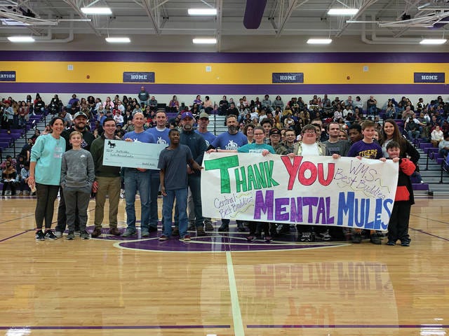 The Mental Mules award the Columbia Best Buddies Chapter a $12,000 check Saturday night at the Central High School vs. Spring Hill basketball game. The money was raised during the Mental Mules’ 24-hour walk. On hand were several Mental Mules walkers, including Juli Beck (Best Buddies parent sponsor), Chris Binkley, Rachel Lombardo and Courtney Scott, Best Buddies teacher sponsors and Central and Whitthorne Middle School chapter members. (Courtesy photo)