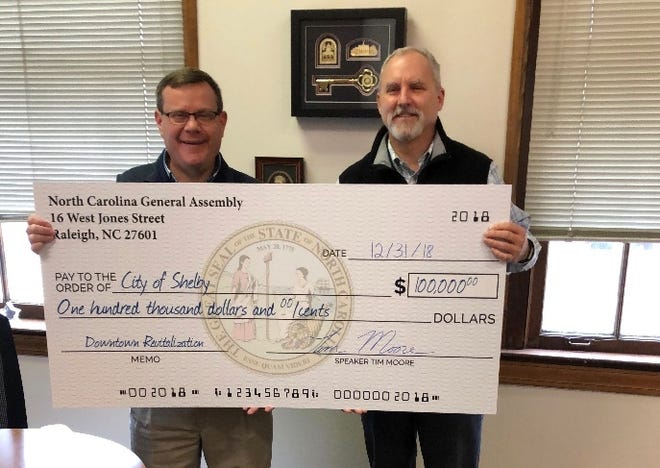 N.C. House Speaker Tim Moore, left, and Shelby City Manager Rick Howell hold a check that will help create a new park. [Special to The Star]