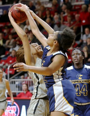 Brittany Davis stuffs the shot of Gabriela Sales in the fourth quarter of the Northwest Florida State womens basketball game against Gulf Coast State College at The Arena. [MICHAEL SNYDER/DAILY NEWS]