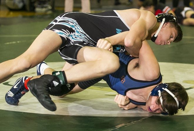 West Port's Jonathan Rodriguez tries to roll Bradenton Christian's Logan Sapuppo as he drives him on the mat. This was Rodriguez's 99th win by pinning Sapuppo. Area high schools competed in the Diamondback Duals wrestling tournament held at Belleview High Saturday. The school hosted the two-day wrestling tournament this weekend. [Doug Engle/Ocala Star-Banner]