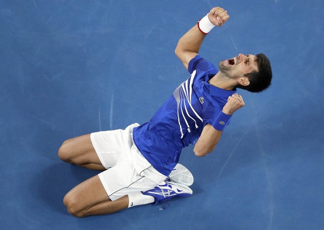 Serbia's Novak Djokovic celebrates after defeating Spain's Rafael Nadal in the men's singles final at the Australian Open tennis championships in Melbourne, Australia, on Sunday. [MARK SCHIEFELBEIN/THE ASSOCIATED PRESS]