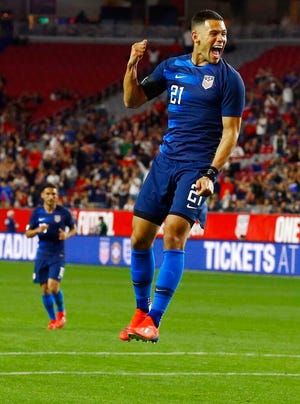 United States forward Christian Ramirez (21) celebrates his goal against Panama as United States midfielder Cristian Roldan, left, looks n during the second half of a men's international friendly soccer match Sunday, Jan. 27, 2019, in Phoenix. The United States defeated Panama 3-0. (AP Photo/Ross D. Franklin)