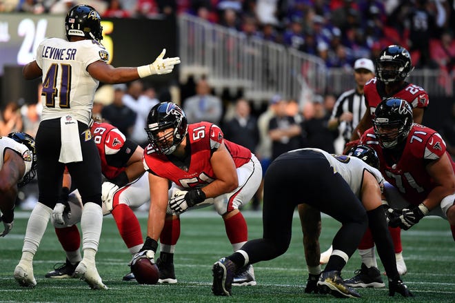 FILE - In this Dec. 2, 2018, file photo, Atlanta Falcons center Alex Mack (51) prepares to work against the Baltimore Ravens during the second half of an NFL football game in Atlanta. Some might argue the center is the most indispensable player on the roster, the player who mans the only position guaranteed to touch the ball on every play. He calls the shots for the line and gets the action going. (AP Photo/Danny Karnik, File)