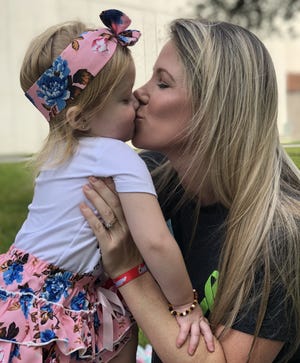 Brittany LaBelle kisses her daughter Ava Leigh LaBelle, 3, who underwent a five-organ transplant at Holtz Children’s Hospital at the University of Miami/Jackson Memorial Medical Center in August. The two are still living in Miami for monitoring and care, while Matthew LaBelle and the couple's four other children remain at home in Ocala. [Photo courtesy LaBelle family]