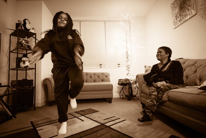 Akirah Carter at home with grandmother Tonya Carter in the Plaza West housing complex in Washington, D.C.   [Photo for The Washington Post by Andre Chung]