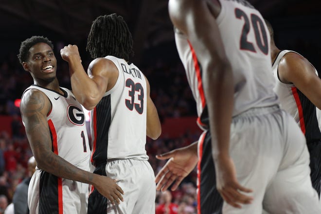 Georgia guard Teshaun Hightower (1) celebrates with forwards Nicolas Claxton (33) and Rayshaun Hammonds (20) after taking a solid lead in the second half of Saturday's 98-88 win over Texas. [JOSHUA L. JONES/ATHENS BANNER-HERALD]