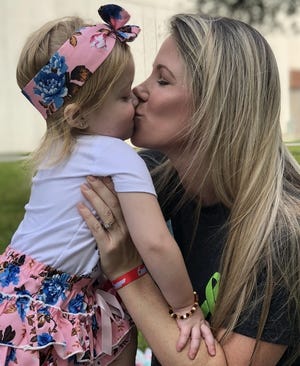 Brittany LaBelle kisses her daughter, Ava Leigh, 3, who underwent a five-organ transplant. [FAMILY PHOTO]