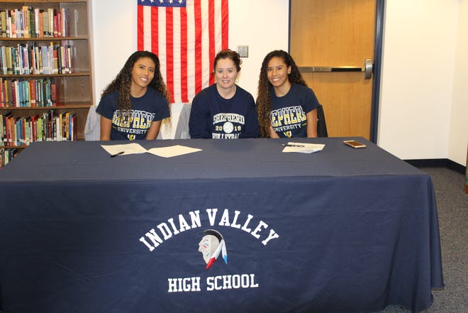 Indian Valley's Kitanna (left) and Kiara Rakestraw surround their mother Angela Robbins after signing to attend college and play volleyball at Shepherd University. Kitanna was a second team All-Ohioan and a first team Inter-Valley Conference performer. She was the Braves leading blocker from her sophomore through senior years and led the team in kills as a senior. She also broke the school record for kill percentage and aces. Kiara led the Braves in digs her senior year and was an Academic All-Ohioan and a first team player in the IVC. She was also claimed the Queen of the Court Award. The twins father is Richard Rakestraw. Their head high school coach was Tera Pryor and their head college coach is Alex Hoekstra. Submitted photo
