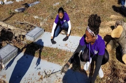 Members of the University of Central Arkansas Foundation’s “Bear Boots on the Ground” clear and clean grave sites at a Millville cemetery. [CONTRIBUTED PHOTO]
