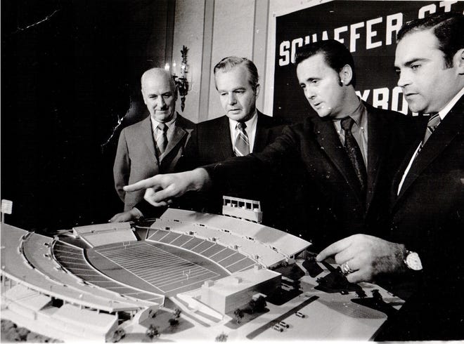 Boston Patriots founder Billy Sullivan, far left, and other officials examine a model of Schaefer Stadium in January 1971. [Houghton Mifflin Harcourt]