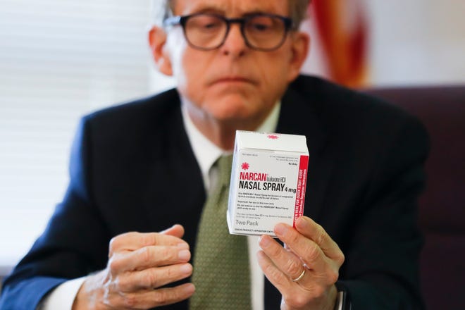 Ohio Gov. Mike DeWine has long focused on the state’s opioid crisis. As attorney general, DeWine is seen here handling a box of the overdose-reversing drug naloxone, whose trade name is Narcan, during a 2017 news conference to announce a program to distribute naloxone more widely in Hamilton County. [File photo]