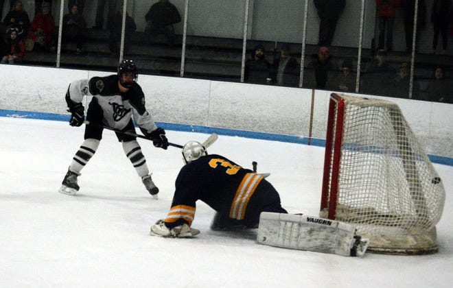 The Indians Charlie Farrah with one of his two goals Monday night against Littleton. [Steve Balestrieri photo]