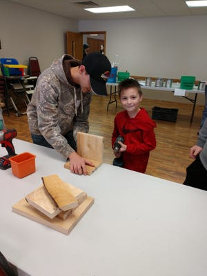 The 2019 4-H Day of Dabbling was held Jan. 26 at the Oregon Church of God. Pictured: Jayden Scott assists Wyatt Sosa with a workshop activity. [PHOTO PROVIDED]