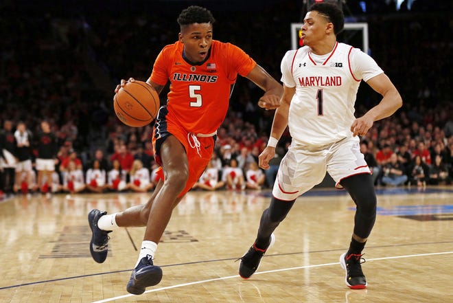 Illinois guard Tevian Jones (5) drives to the basket past Maryland guard Anthony Cowan Jr. (1) during the second half of an NCAA college basketball game Saturday, Jan. 26, 2019, in New York. Illinois defeated Maryland 78-67. (AP Photo/Adam Hunger)