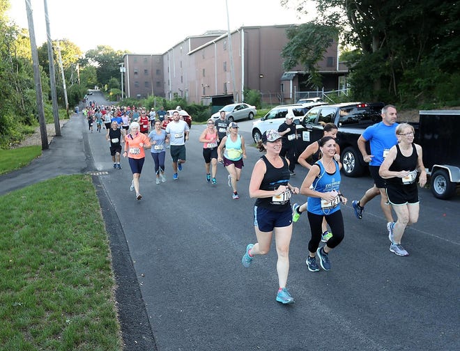 Runners race toward Osprey Overlook Park during a 5K race held by Old Colony Running Events to benefit the family of fallen Weymouth Police Sgt. Michael Chesna, 41, and the Vera Adams Memorial Fund last August. A similar road race will be held at Barrell House Z Brewery in East Weymouth to benefit the Adams Memorial Fund at 9:30 a.m. Feb. 3. 

[Wicked Local File Photo]