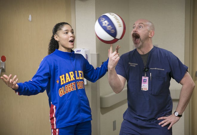 Ace Jackson of the World Famous Harlem Globetrotters, takes time to entertain nurse Seth Marantz, right, with the Pediatric unit at St. David's Children's Hospital Center last year. the basketball team returns to Austin Friday. 

[AMERICAN-STATESMAN]