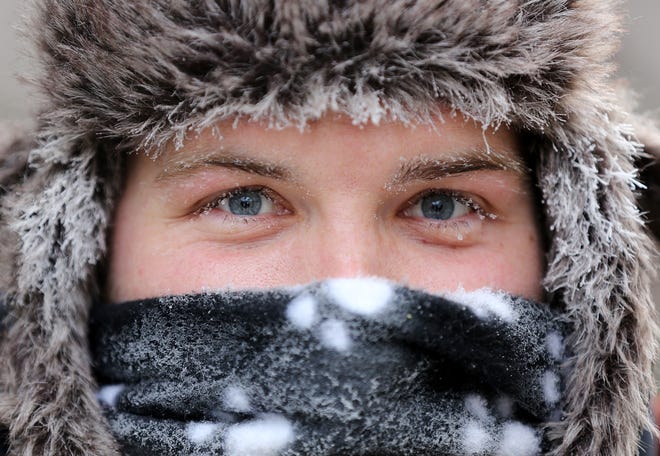 Zookeeper, Josh Keller, works quickly in the reindeer and moose enclosures, while he tries to stay warm with sub zero temperatures, at the Columbus Zoo and Aquarium, Wednesday, January 30, 2019. The animals in the North American exhibits weren't fazed by the cold temperatures but the zoo took extra precautions for its keepers. (Dispatch photo by Courtney Hergesheimer)