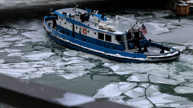 A boat cuts through the ice in the Chicago River near the Michigan Avenue Bridge as the frigid temperatures continue in Chicago on Tuesday. (Antonio Perez / Chicago Tribune / TNS)