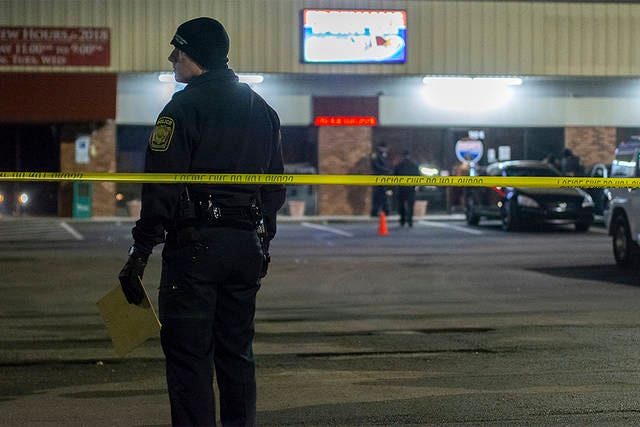 CRIME SCENE — An Asheboro Police Officer guards a crime scene after a shooting at Parkway Plaza on Zoo Parkway early Sunday morning. (Scott Pelkey / The Courier-Tribune)