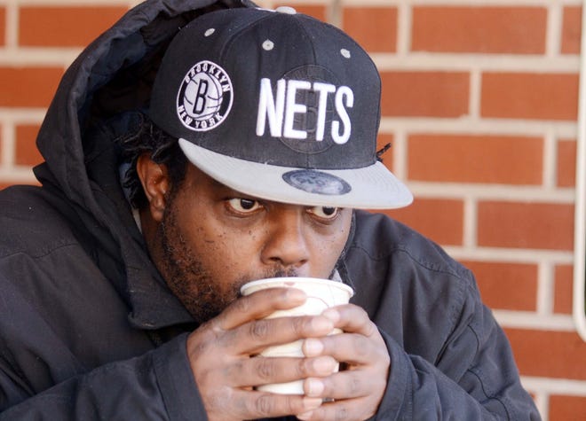 Marlow Bickham, of Norwich, sips hot coffee to stay warm Wednesday outside Otis Library in downtown Norwich. Bickham said, "I feel cold weather is good for the soul." See more photos at NorwichBulletin.com [John Shishmanian/ NorwichBulletin.com]