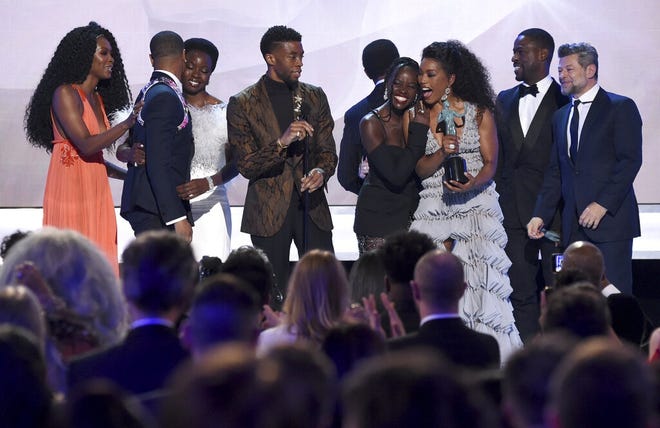 The cast of 'Black Panther' accepts the award for outstanding performance by a cast in a motion picture at the 25th annual Screen Actors Guild Awards at the Shrine Auditorium & Expo Hall on Sunday, Jan. 27, 2019, in Los Angeles. The movie is being re-released this Friday for a limited run to mark Black History Month. People can receive free tickets online. [Photo by Richard Shotwell/Invision/AP]