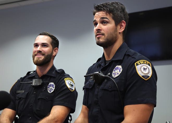 Gainesville Police Department officers Michael Hamill, left, and Dan Rengering speak at a press conference following a viral selfie taken during Hurricane Irma in 2017. Hamill later came under fire for anti-Semitic posts made on his personal Facebook page and resigned. [GAINESVILLE SUN FILE PHOTO]