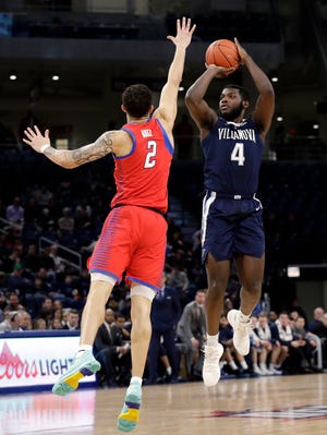 Villanova forward/guard Eric Paschall, right, shoots against DePaul forward Jaylen Butz during the first half of an NCAA college basketball game Wednesday, Jan. 30, 2019, in Chicago. (AP Photo/Nam Y. Huh)