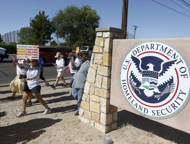 This June 2018 photo shows protesters walking along Montana Avenue outside the El Paso Processing Center, in El Paso, Texas. Federal immigration officials are force feeding some of the immigrants who have been on hunger strike for nearly a month inside the Texas detention facility, The Associated Press has learned. [Rudy Gutierrez/AP Photo]