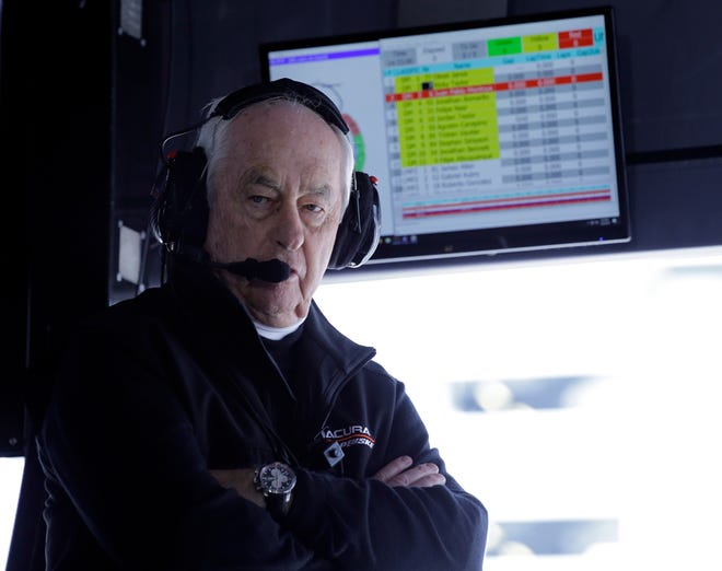 FILE - In this Jan. 26, 2019, file photo, Penske Acura team owner Roger Penske monitors his Acura DPi cars on the track from his pit stall at the IMSA 24-hour race at Daytona International Speedway in Daytona Beach, Fla. Penskeâ€™s drivers swept all the races at Indianapolis Motor Speedway and his reward has been induction into the NASCAR Hall of Fame. Penske will be honored Friday night along with Jeff Gordon, deceased drivers Davey Allison and Alan Kulwicki and fellow team owner Jack Roush. (AP Photo/Terry Renna, File)