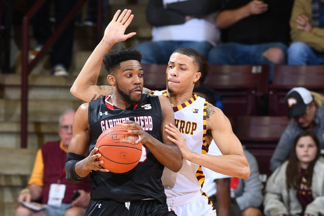 Gardner-Webb's D.J. Laster tries to break free to take a shot against Winthrop at the Winthrop Coliseum on Jan. 24. [Tim Cowie / GWUPhotos.com]