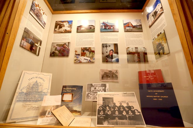 A display box features local churches and pastors, with some artifacts, as part of the new exhibit "Past, Present & Future: African American Community in Reno County," at the Reno County Museum. [Sandra J. Milburn/HutchNews]