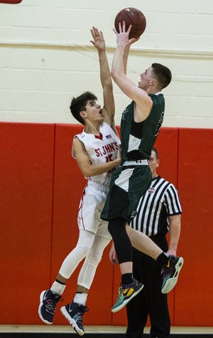 SHREWSBURY - Wachusett's Sam Dion takes a shot over the head of St. John's Beau O'Beirne during the game on Tuesday, January 29, 2019. [T&G Staff/Ashley Green]