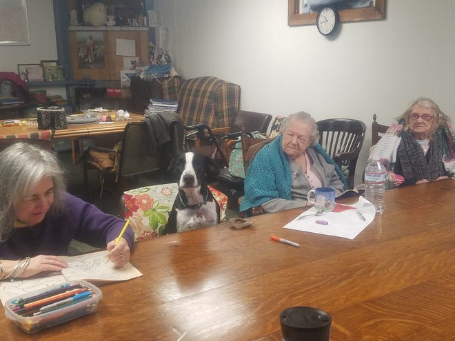 Australian cattle dog Fiona enjoys some quality time with adult day care clients at Seaside Elderly Day Out Center in Hampton. Courtesy photo