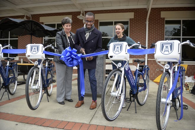 Augusta University VP for Academic and Faculty Affairs Dr. Kathy Browder, from left, Student Government Association President LeDarius Scott and Gotcha Mobility Project Manager Hannah Bond cut the ribbon on the new ride share bike program at the Augusta University Summerville campus in Georgia. The Springfield City Council is considering signing an agreement with Gotcha to bring a similar program to the city. [MICHAEL HOLAHAN/THE AUGUSTA CHRONICLE]