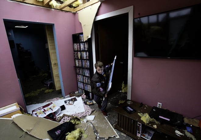 David Bowers retrieves items from the interior of his tornado damaged Taylorville home Sunday, Dec. 2, 2018. The roof of the home was completely torn off by the storm. [Ted Schurter/The State Journal-Register]