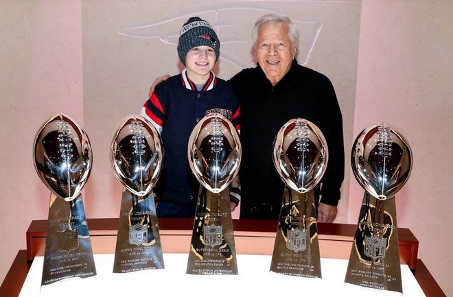 New England Patriots owner Robert Kraft shows Dejah Rondeau the team's Super Bowl trophies. [ERIC ADLER/NEW ENGLAND PATRIOTS]