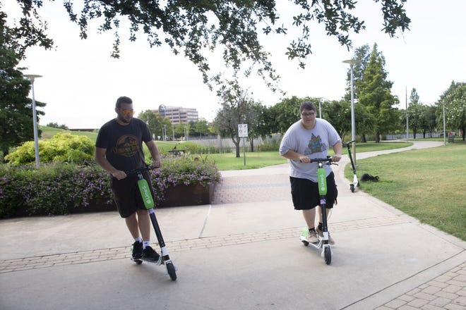 New Braunfels has placed a moratorium on dockless rental scooters like these Lime-S scooters, shown being ridden in downtown Austin last summer. [LYNDA M. GONZALEZ / AMERICAN-STATESMAN]