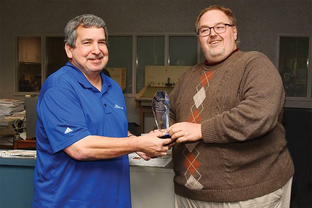 SCORE ONE FOR DENNIS — Sports Editor Dennis Garcia, left, accepts the 2018 Employee of the Year award from Todd Benz, general manager of The Courier-Tribune . (Contributed)