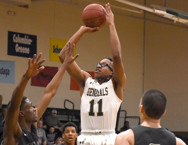 Musa Pough (11) shoots over Mohawk Valley Community College defenders for Herkimer College during the second half of Wednesday's game.      

[Jon Rathbun / Times Telegram]