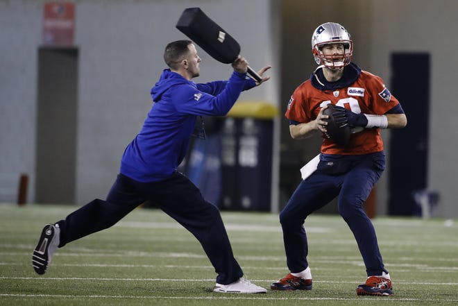 New England Patriots quarterback Tom Brady, right, looks to pass during NFL practice on Friday in Atlanta as the team prepares for Super Bowl LIII against the Los Angeles Rams on Sunday. [AP PHOTO/MATT ROURKE]
