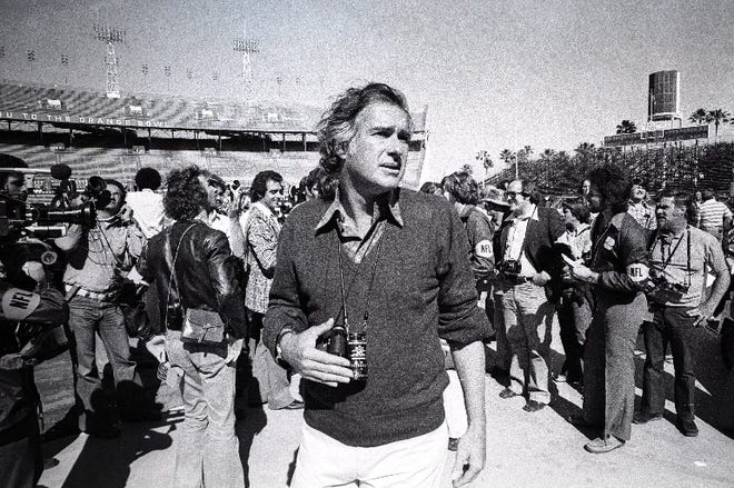 January 29, 1976 : Director John Frankenheimer stands among news photographers at the Orange Bowl in Miami during the filming of the movie, "Black Sunday." Real news photographers were recruited as extras to pretend to be shooting Super Bowl X, and then to turn and photograph the crowd fleeing the stands, as the blimp crashes into the Orange Bowl. [JOHN J. LOPINOT/palmbeachpost.com]