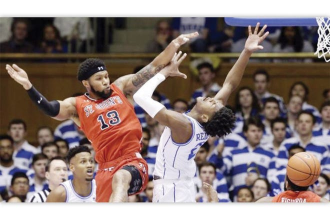 OUCH! — St. John's Marvin Clark II (13) fouls Duke's Cam Reddish (2) during the first half of the Blue Devils' win Saturday at Cameron Indoor Stadium.