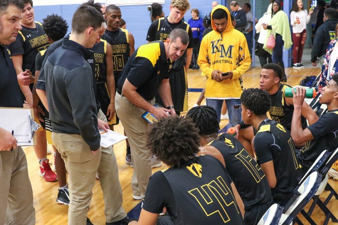 Kings Mountain boys basketball coach Grayson Pierce instructs the team during Friday's game at Hunter Huss in Gastonia. [Bill Bostick/Special to The Star]