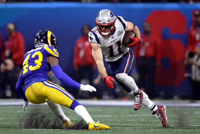 New England Patriots' Julian Edelman, right, tries to elude Los Angeles Rams' John Johnson III (43) after catching a pass during the second half of the NFL Super Bowl 53 football game Sunday, Feb. 3, 2019, in Atlanta. (AP Photo/Carolyn Kaster)